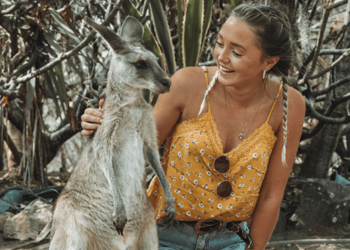 female backpacker meeting a kangeroo in australia