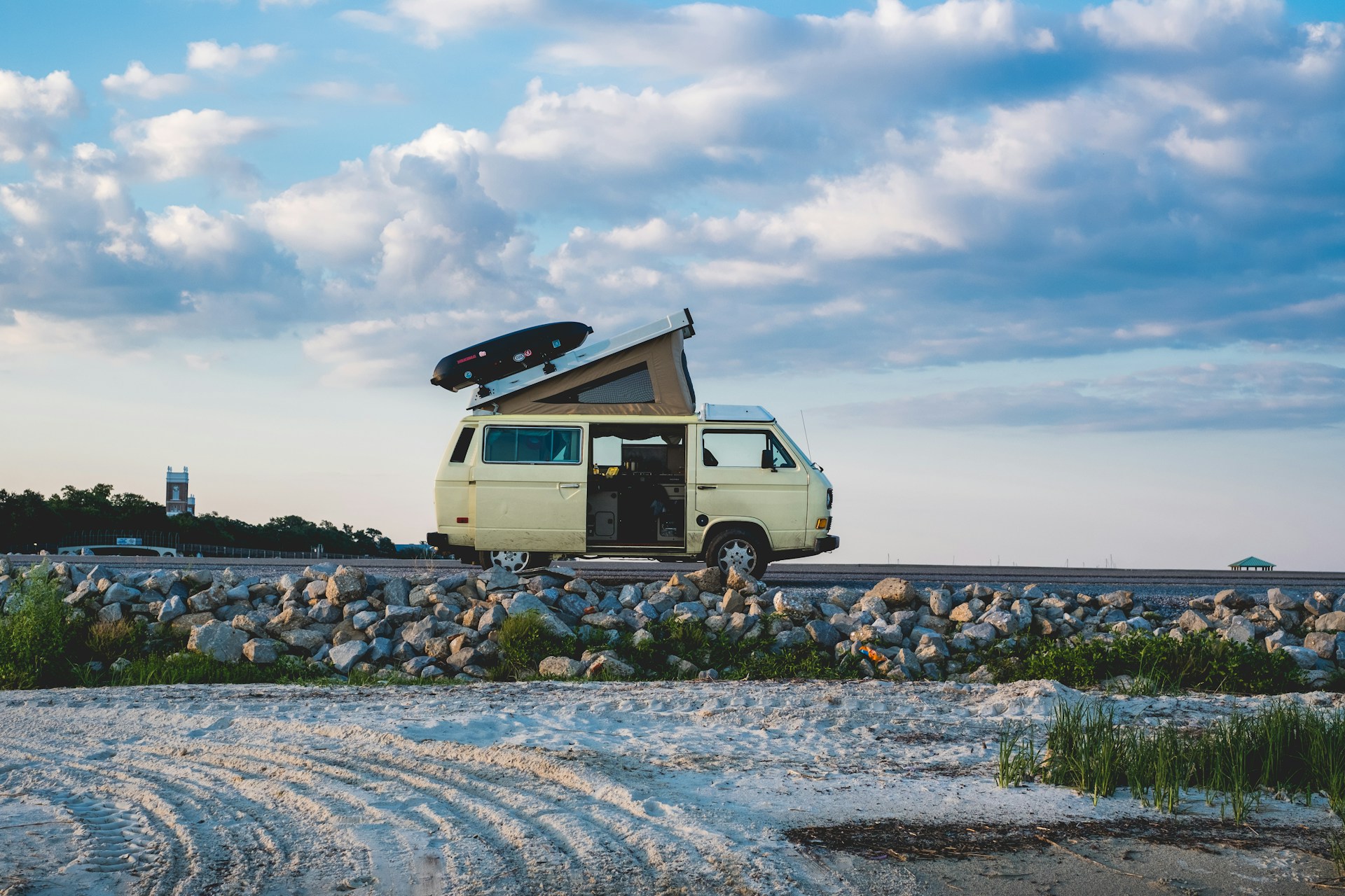 A pop-top campervan by the beach