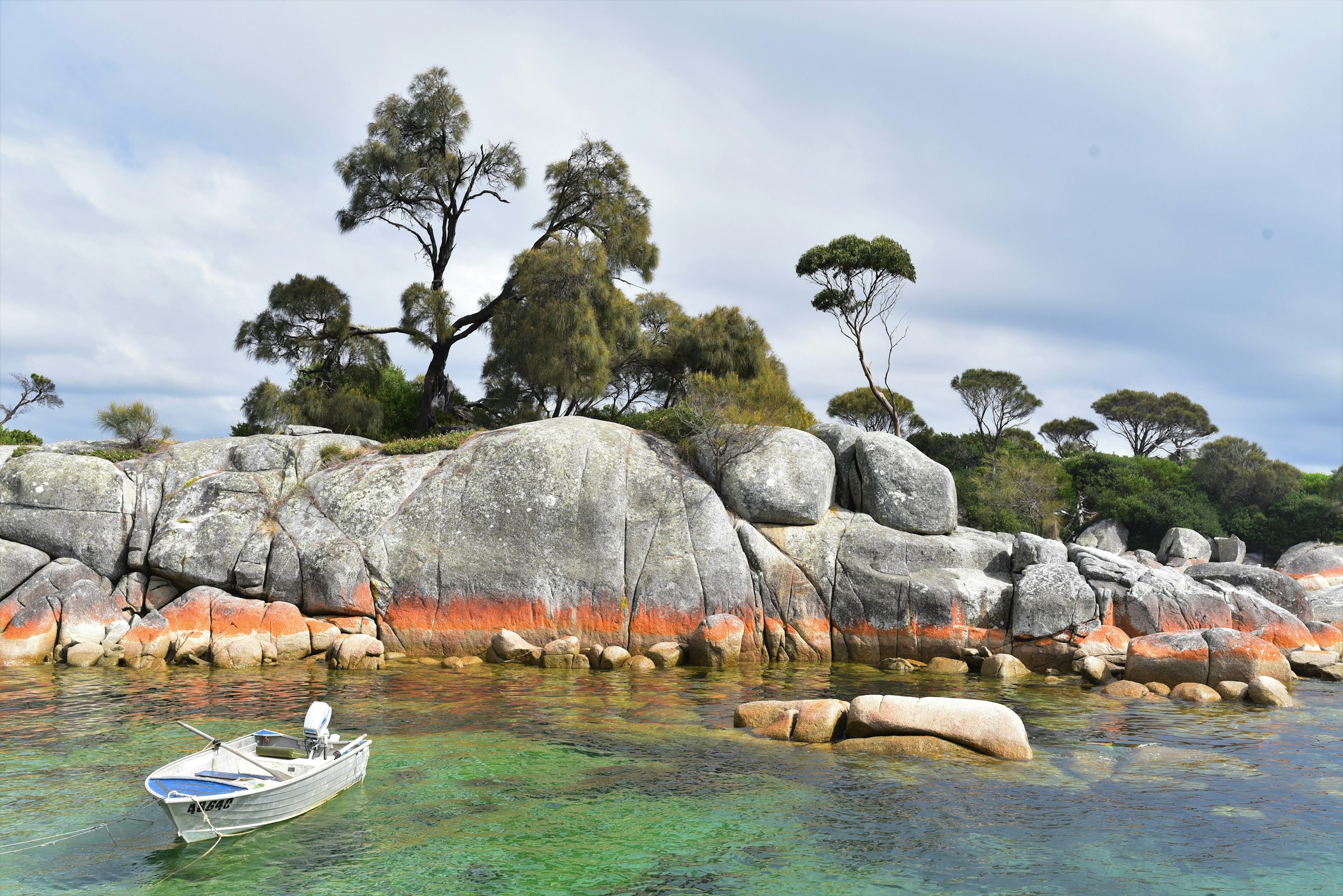 A boat and coastline at The Bay of Fires, Tasmania