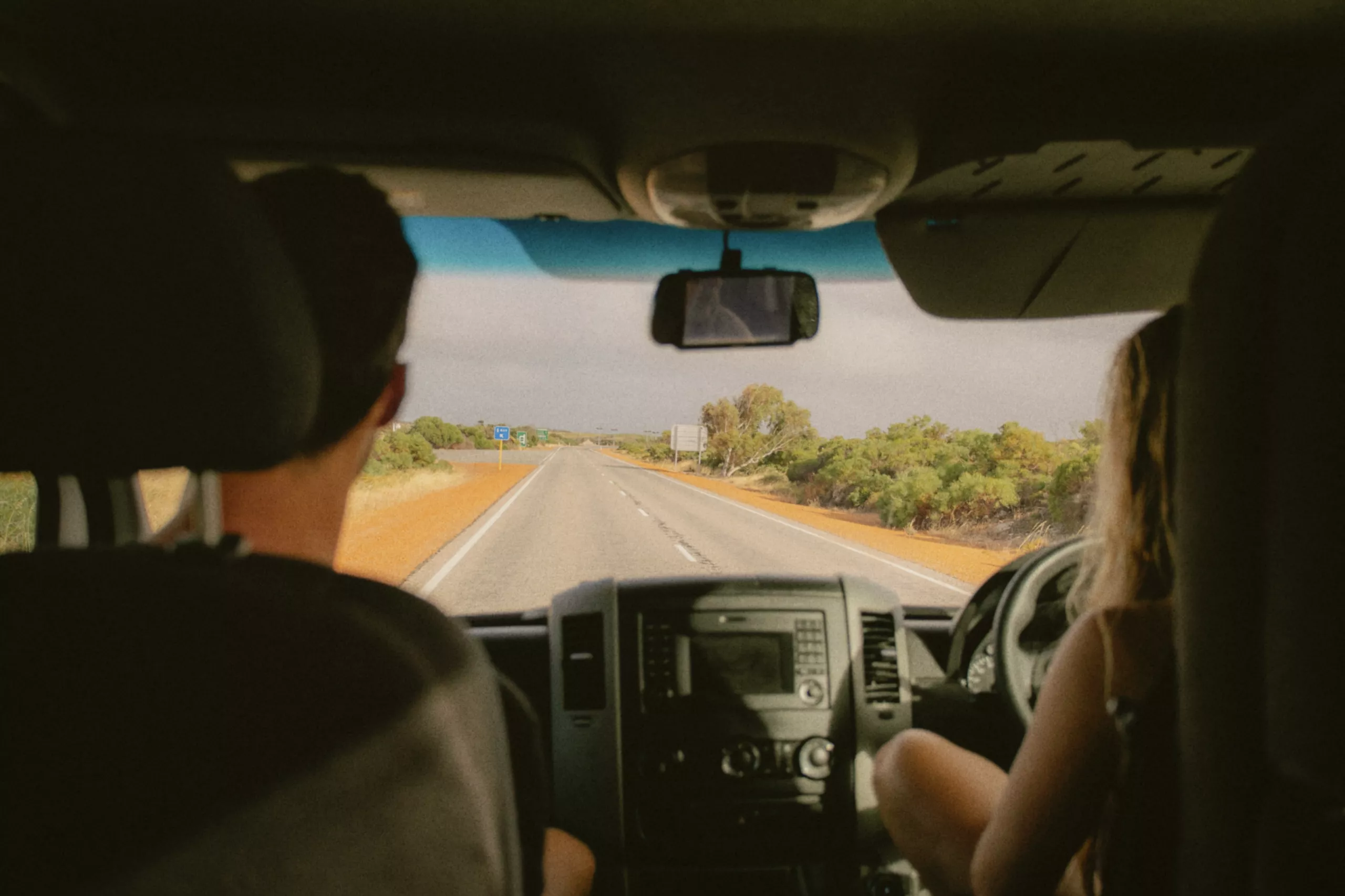 The Best Road Trips In Australia Two people driving in a campervan