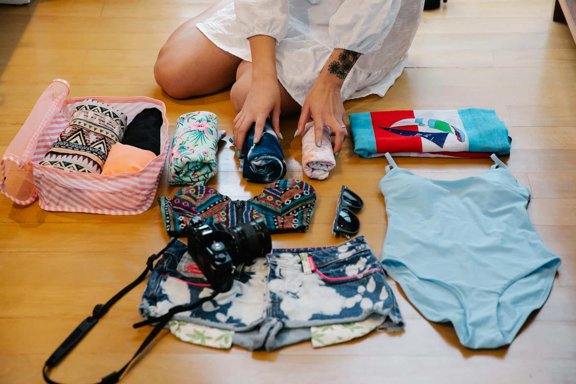 A woman packing clothes for a summer holiday