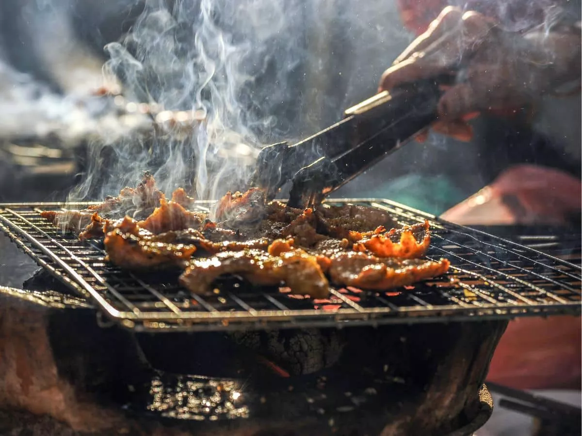 Sizzling meat on a BBQ.