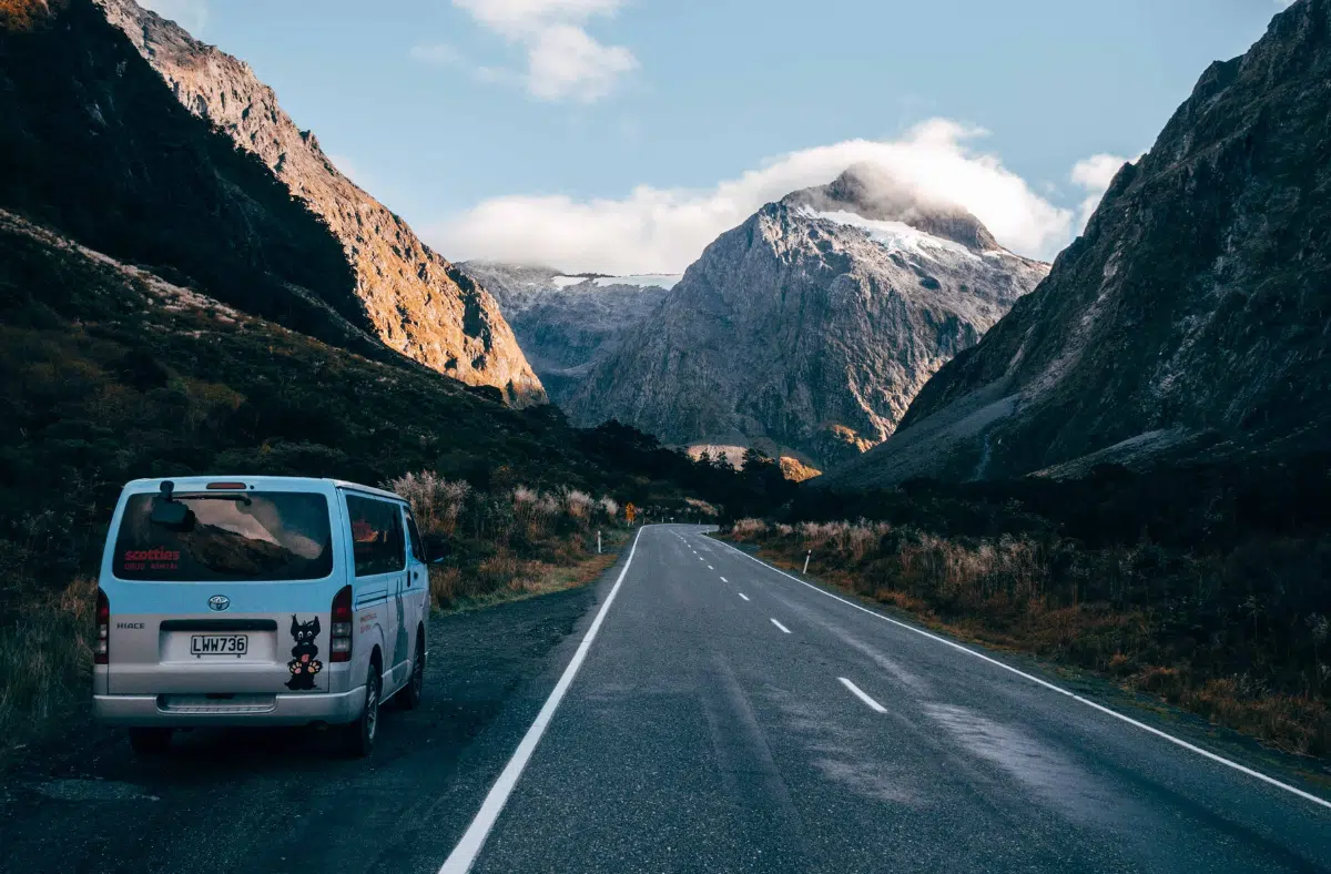 A campervan parked roadside in the middle of New Zealand's wild mountain ranges — the ultimate ‘freedom camping’ kinda vibe